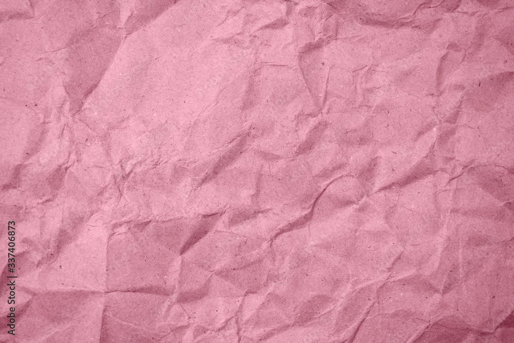 Fototapeta premium Crumpled pink paper in the background