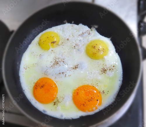 fried eggs in a frying pan, sunny side up