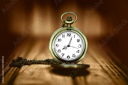 Vintage pocket watch on a wooden background. Selective focus