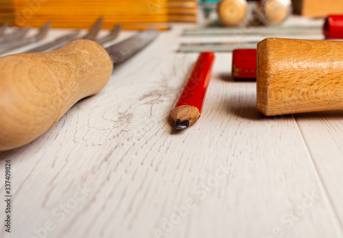 ordered carpenter tools on white wooden board photo