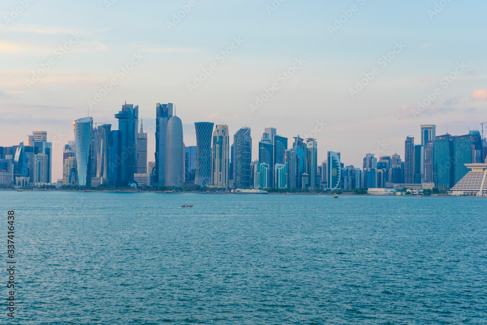 View of modern skyscrapers and bay at twilight in Doha, Qatar View of modern skyscrapers and bay at twilight in Doha, Qatar