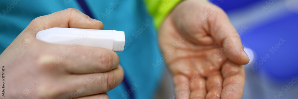 Man hold in hand white bottle of sanitizer Man hold in hand white bottle of sanitizer