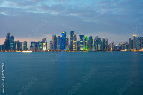 View of modern skyscrapers and bay at twilight in Doha, Qatar