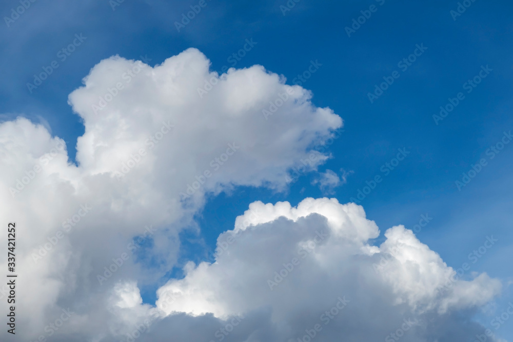 White clouds against blue sky on sunny day. Background image. White clouds against blue sky on sunny day. Background image.