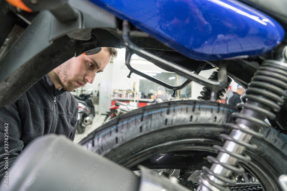 Mechanic repairs motorcycles at the workshop. Tire change. Mechanic repairs motorcycles at the workshop. Tire change.