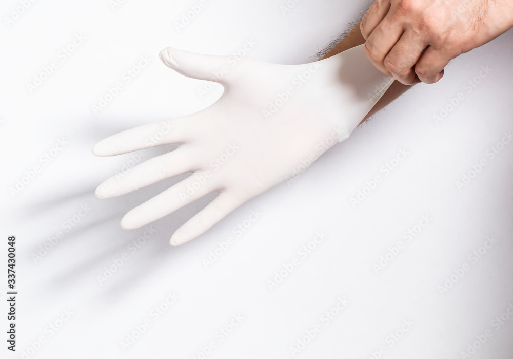 Person putting on surgical latex gloves