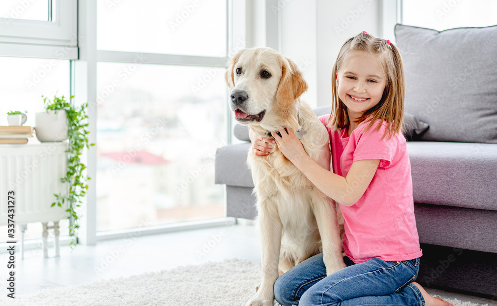 Smiling little girl cuddling cute dog Smiling little girl cuddling cute dog
