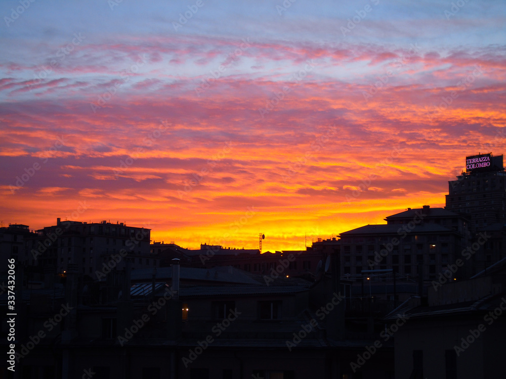 Genova, Italy - 04/08/2020: An amazing view from the window of some birds and beautiful sunset over the city while quarantining from home in Italy.