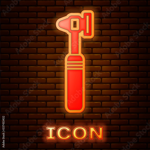 Glowing neon Medical otoscope tool icon isolated on brick wall background. Medical instrument.  Vector Illustration