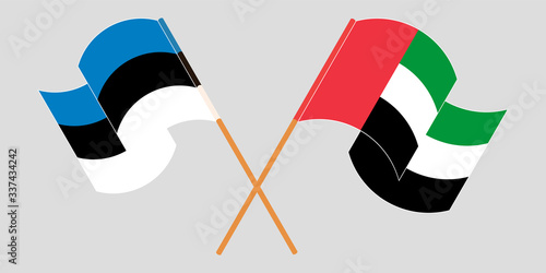 Crossed and waving flags of Estonia and the United Arab Emirates