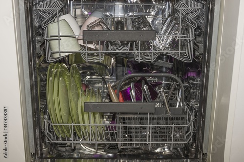Close up view of open dishwasher. Technology background, 