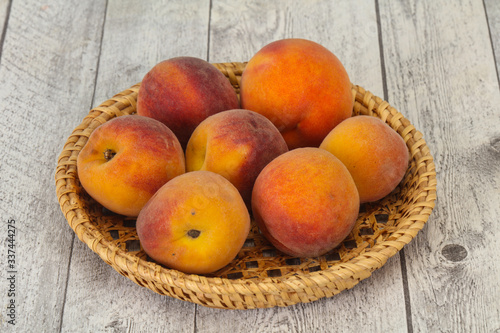 Peach heap in the wooden basket