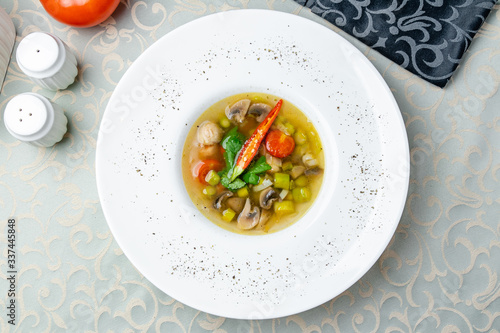Vegetable soup minestrone on white plate