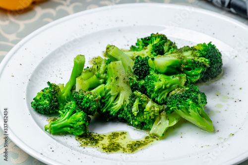 broccoli in garlic sauce on white plate
