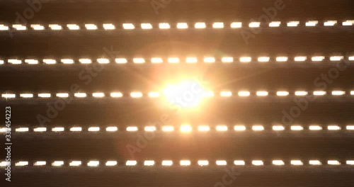 Electric shutters closes and the sun shines through the blinds. (High key to Low key).