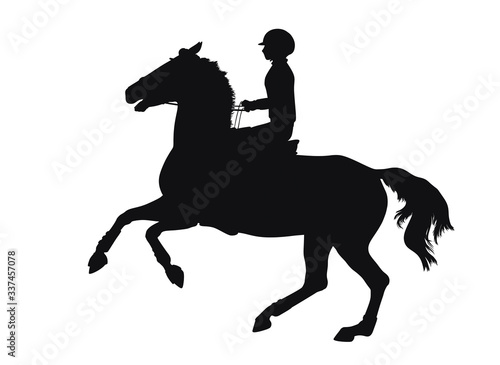 Silhouette of a young athlete cantering on a horse quickly