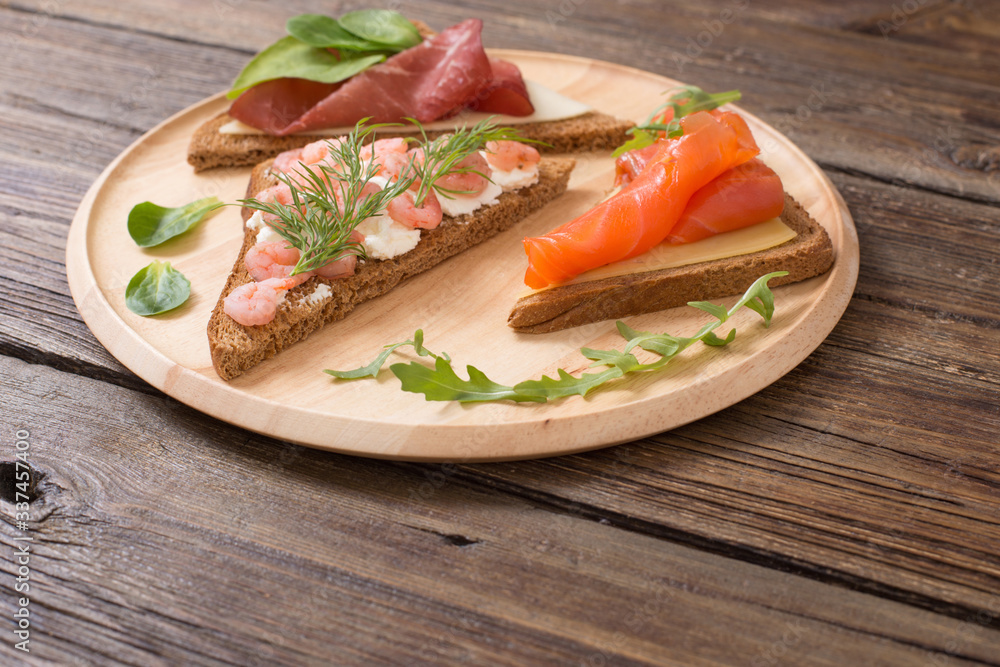 healthy sandwiches on wooden plate  on old wooden table