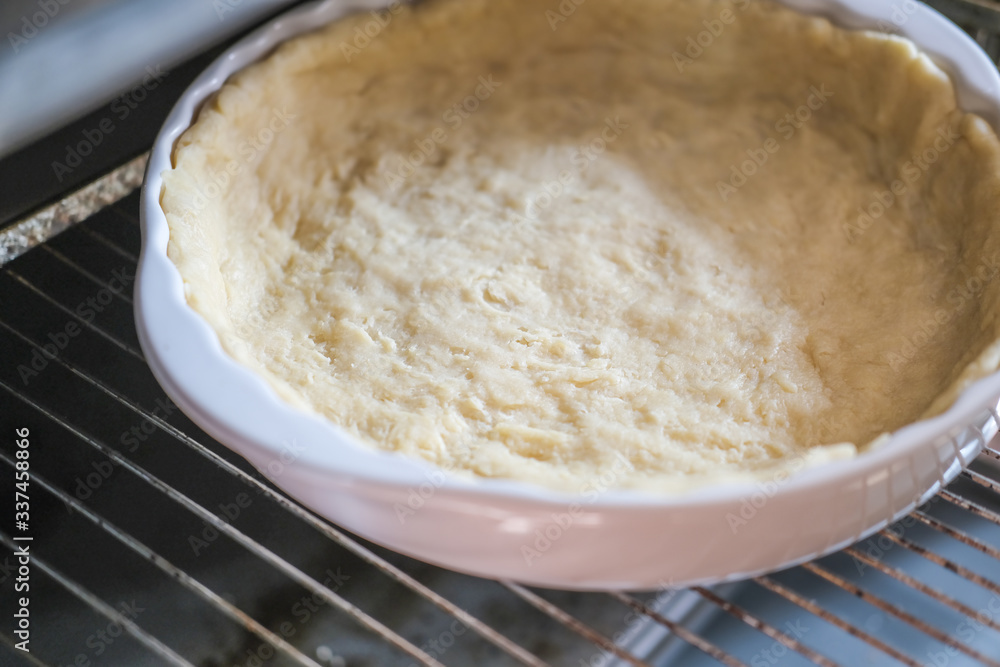 step by step visual instruction, ingredients to prepare salmon quiche tart. Homemade quiche with salmon and cheese. step 4, crust in baking tray step by step visual instruction, ingredients to prepare salmon quiche tart. Homemade quiche with salmon and cheese. step 4, crust in baking tray