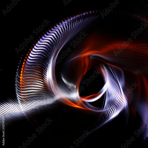 Long exposure photograph of multicolored light trails forming a complex twisted geometric pattern of parallel lines against a dark background. Only photo, no illustration.