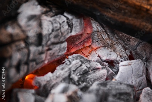 Glowing embers at the heart of a wood fire. Campfire  outdoors  rustic setting.