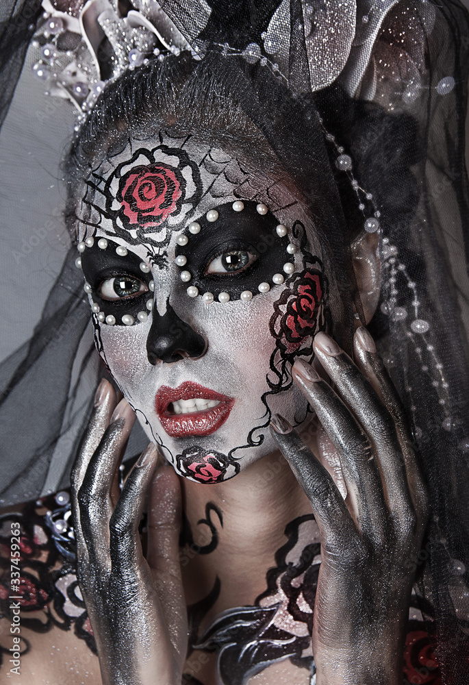 close up portrait of young beautiful  sexy girl with professional Halloween makeup. Mexican death