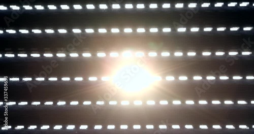 Electric shutters open and the sun shines through the blinds. (Low key to High key).