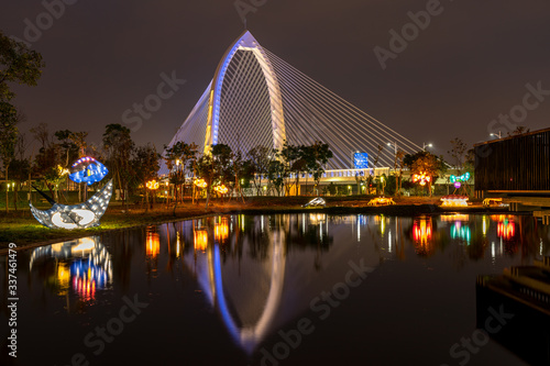 Nightscape of new landmark Konan Ai-Qin Bridge in Taichung City, Taichung Central Park at the Xitun District Shuinan Economic and Trade Area. The second largest park in Taiwan photo