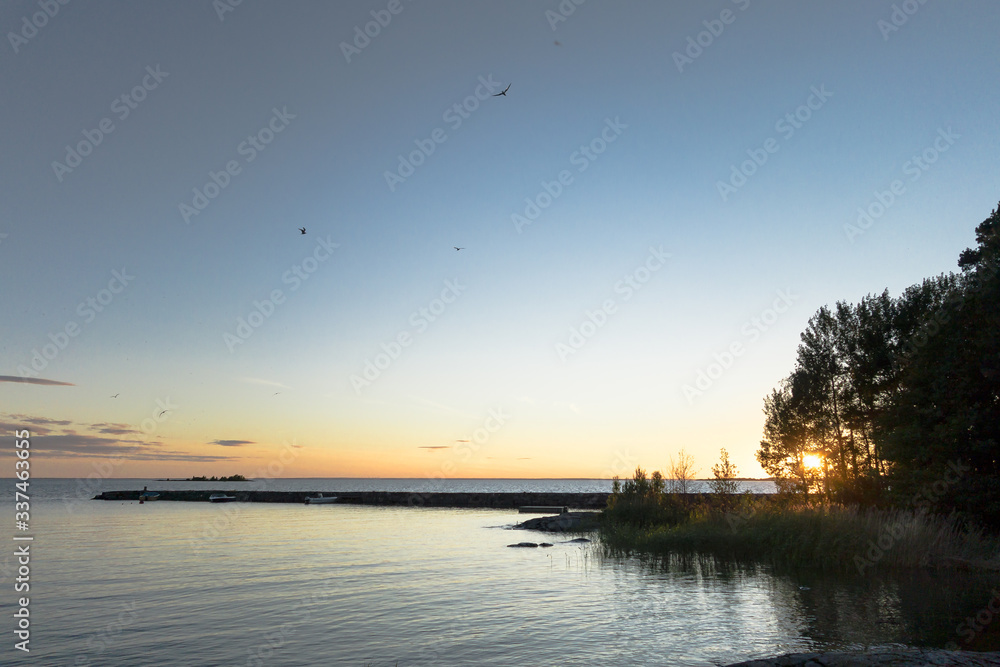 A pier in Lake Vänern against a summer sunset