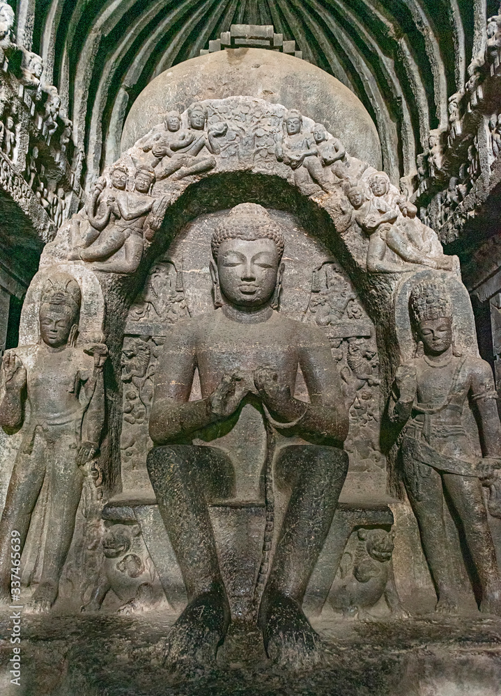 Ellora Cave 10, a 7th-century Buddhist Chaitanya hall, or shrine, features a towering seated Buddha sculpted with hands in the dharmachakra mudra (or “teaching pose”), Aurangabad, Maharashtra, India