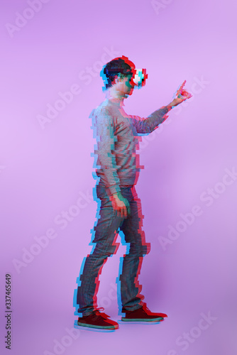 Man is using virtual reality headset. Image with glitch effect. © nuclear_lily