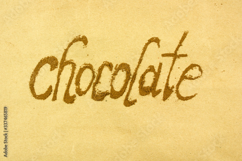 the word chocolate is written with cocoa powder, chocolate mood, top view