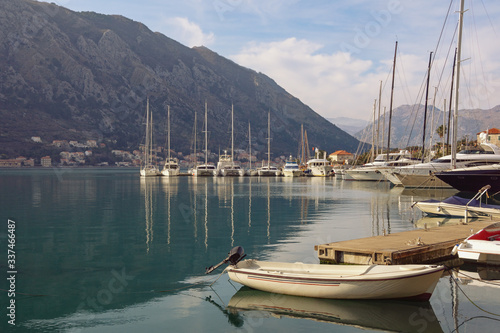 Port in Kotor city. Yachts and fishing boats on water on winter day. Montenegro  Adriatic Sea  Kotor Bay