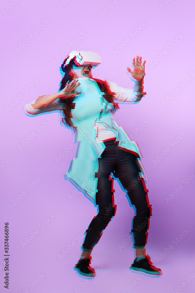 Fototapeta premium Woman is using virtual reality headset. Image with glitch effect.