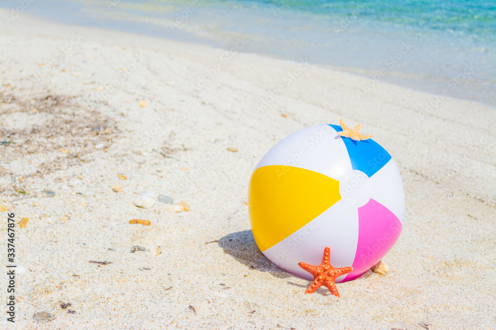 Beach ball and star fish on the sand Beach ball and star fish on the sand