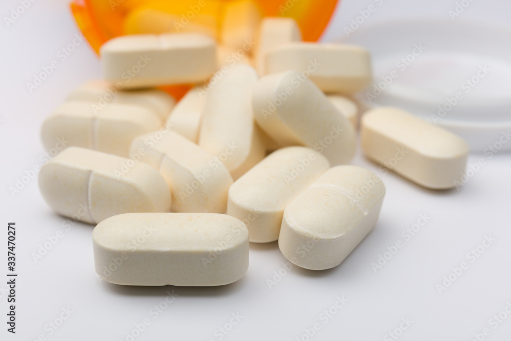 Pills spilling out of pill bottle Pills spilling out of pill bottle
