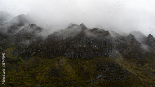 a beautiful mountain view with fog and clouds photo