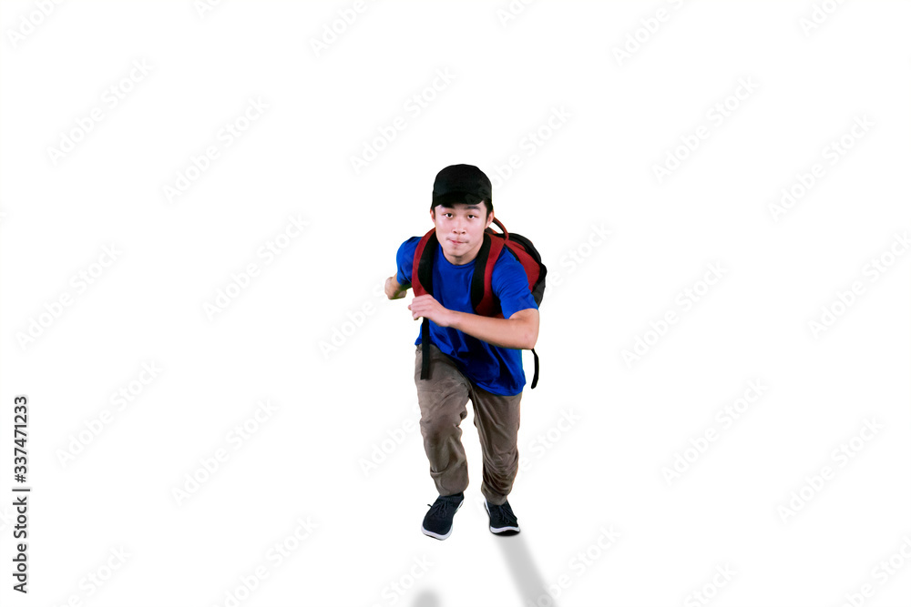 Young student running with hat and rucksack