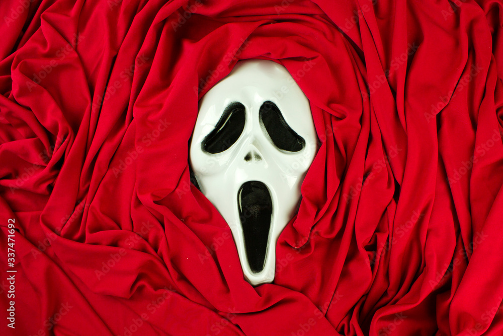 intimidating masquerade face mask, scream mask, image, death symbol, red background Stock | Adobe Stock