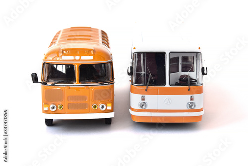 Scale model of a white and yellow Russian buses. Toy yellow bus