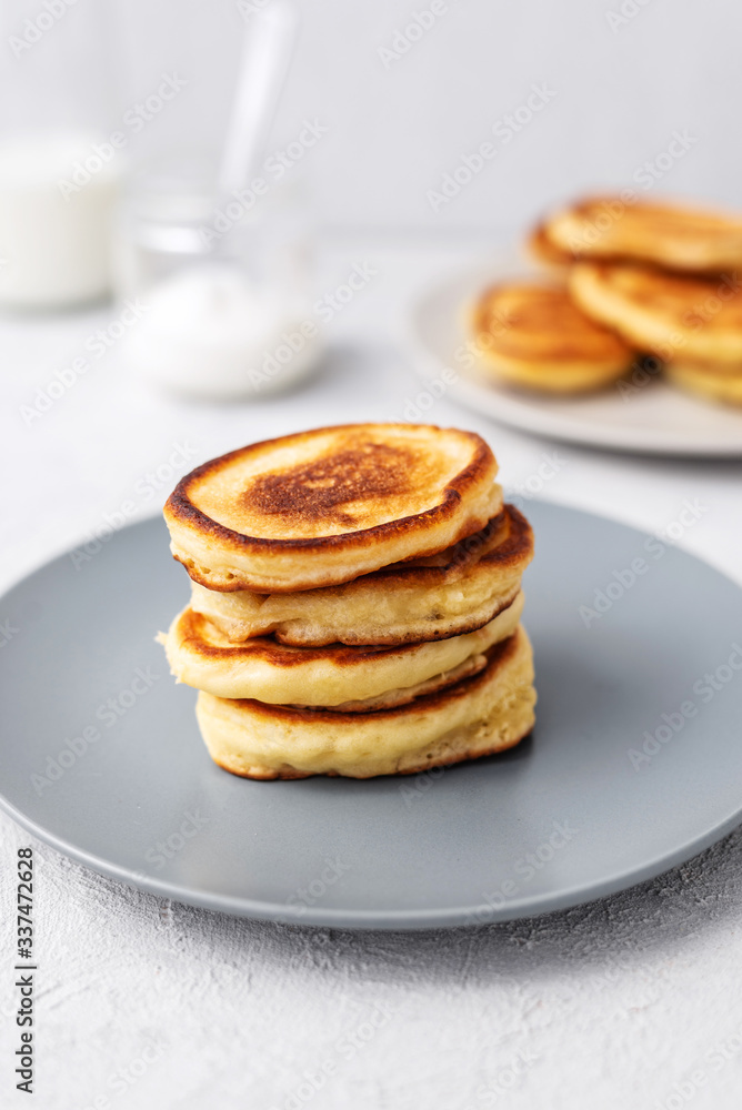 Pancakes. Stack of pancakes with honey on a gray background. Homemade breakfast Pancakes. Stack of pancakes with honey on a gray background. Homemade breakfast