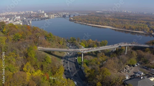 people walk carefree - Pedestrian-bicycle bridge over Vladimirsky descent and Peoples' Friendship Arch, Khreshchatyi park photo