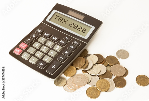 finances, calculator and coins on a bright table
