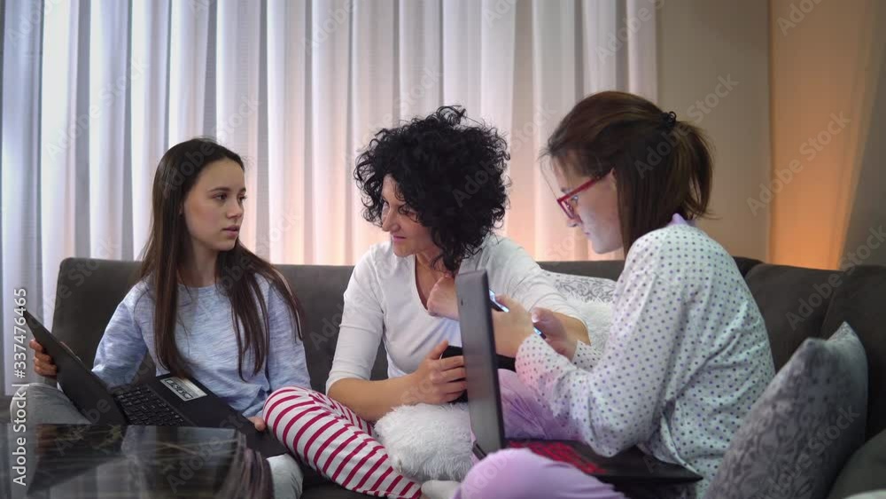 Family smart working and education with video conference. Sitting relaxed in pajama at home preventing spread of corona covid-19 virus, world pandemic Family smart working and education with video conference. Sitting relaxed in pajama at home preventing spread of corona covid-19 virus, world pandemic