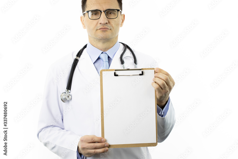 Serious male senior age doctor in white lab coat and stethoscope showing clipboard with blank paper to write on it personal message or advice. Healthcare, insurance and medical suggestion concept Serious male senior age doctor in white lab coat and stethoscope showing clipboard with blank paper to write on it personal message or advice. Healthcare, insurance and medical suggestion concept