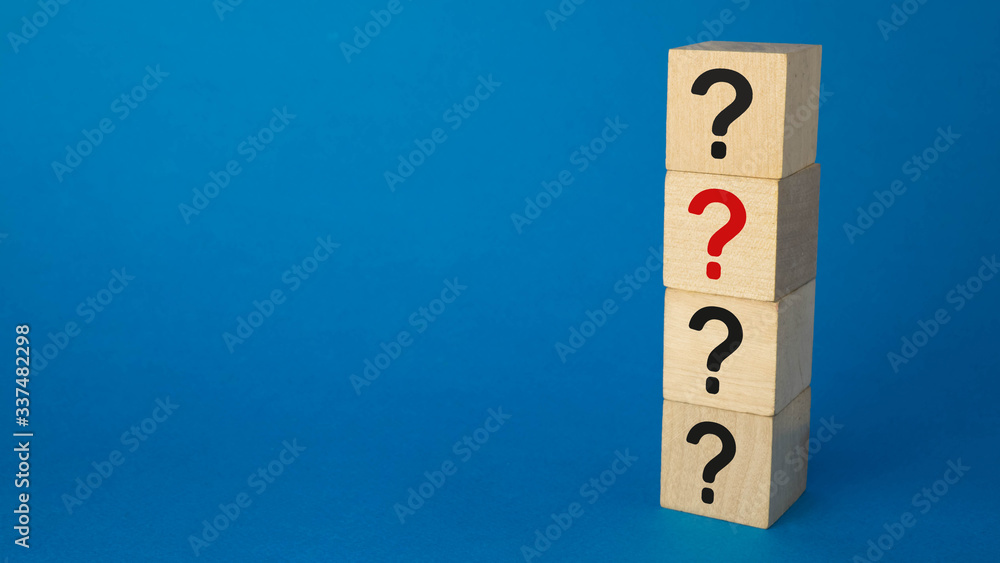 four cubes with question marks of black and one red on a blue background four cubes with question marks of black and one red on a blue background