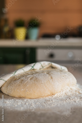 yeast dough for bread on a table in the kitchen