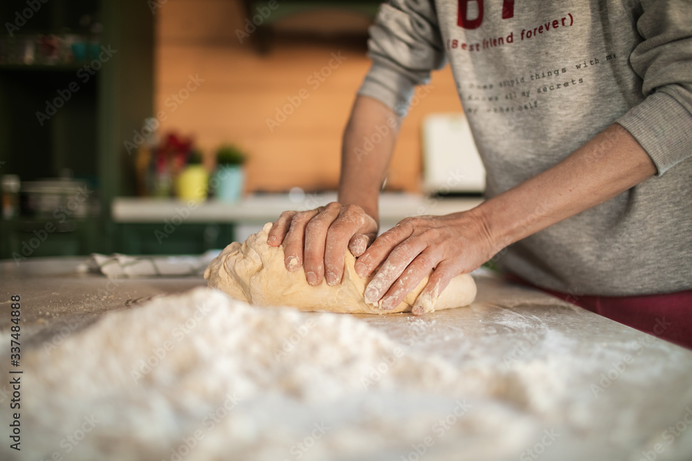 woman baker kneading dough