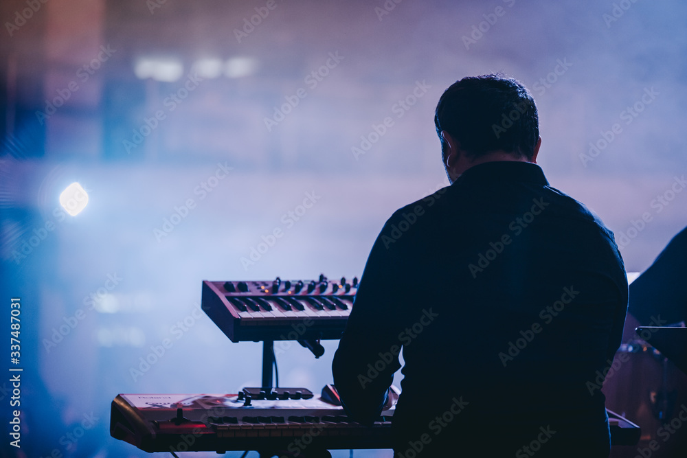 A musician playing synthesizer during the concert