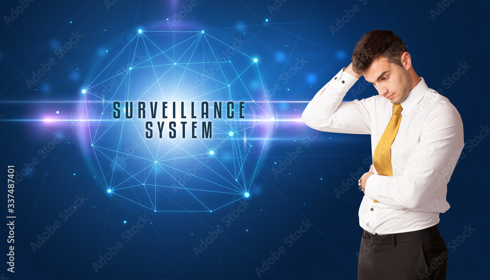 Businessman thinking about security solutions with SURVEILLANCE SYSTEM inscription Businessman thinking about security solutions with SURVEILLANCE SYSTEM inscription