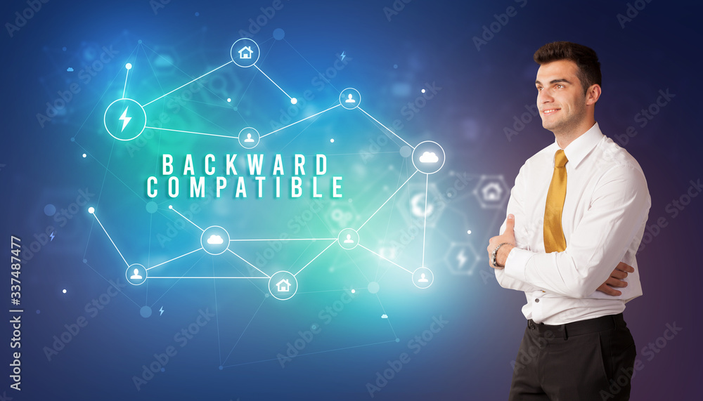 Businessman in front of cloud service icons with BACKWARD COMPATIBLE inscription, modern technology concept Businessman in front of cloud service icons with BACKWARD COMPATIBLE inscription, modern technology concept